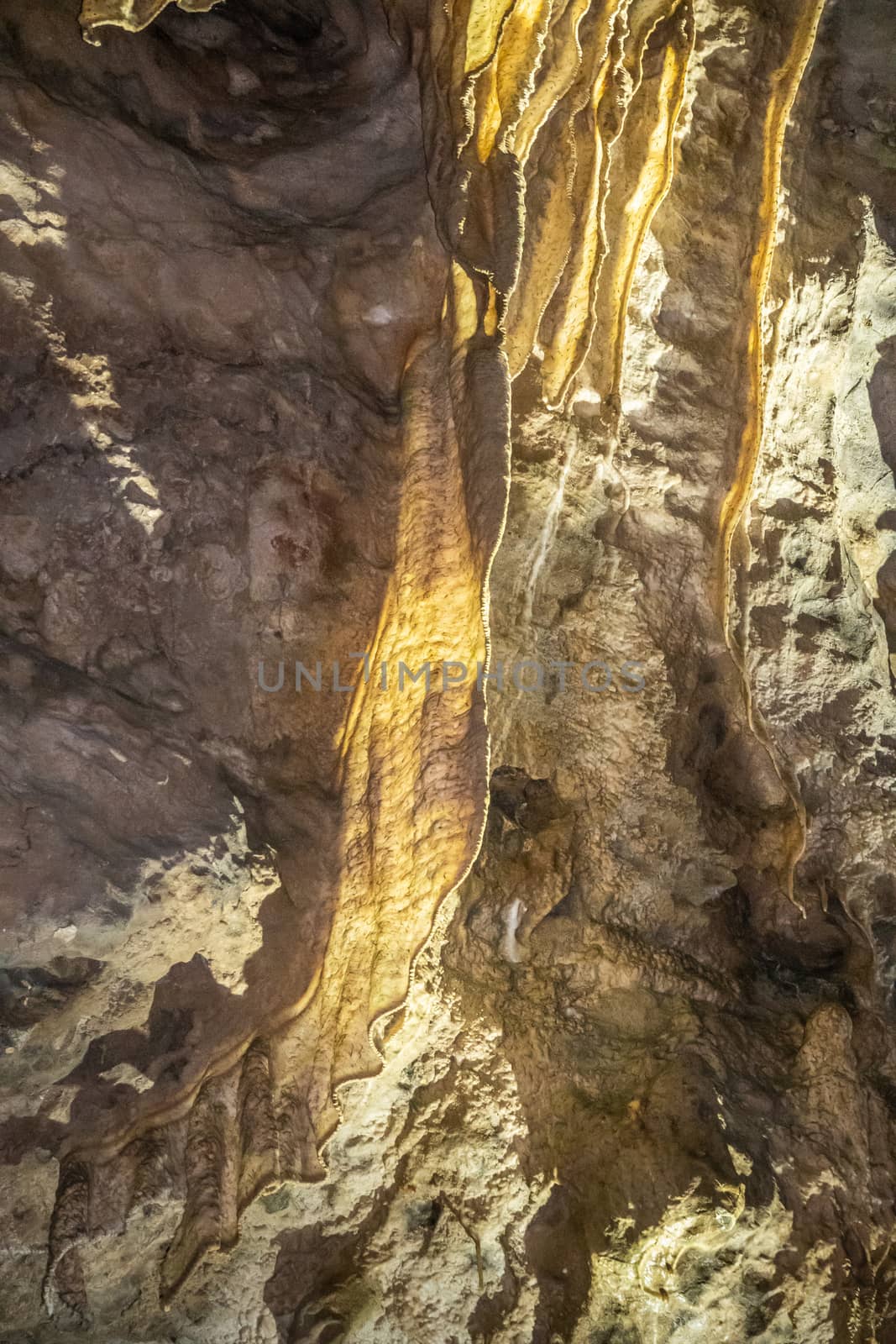 Han-sur-Lesse, Belgium - June 25, 2019: Grottes-de-Han 14 of 36. subterranean pictures of Stalagmites and stalactites in different shapes and colors throughout tunnels, caverns and large halls. Rock curtains.