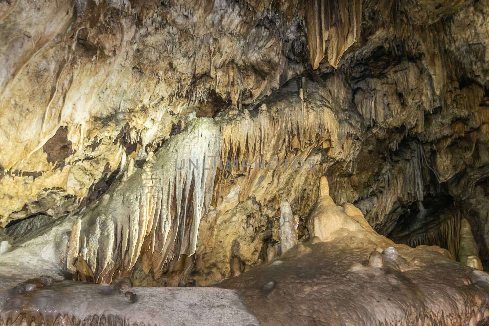 Han-sur-Lesse, Belgium - June 25, 2019: Grottes-de-Han 15 of 36. subterranean pictures of Stalagmites and stalactites in different shapes and colors throughout tunnels, caverns and large halls. Rock curtains.