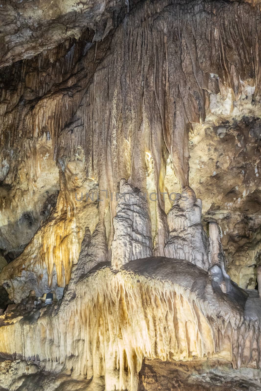 Han-sur-Lesse, Belgium - June 25, 2019: Grottes-de-Han 16 of 36. subterranean pictures of Stalagmites and stalactites in different shapes and colors throughout tunnels, caverns and large halls. Rock curtains.