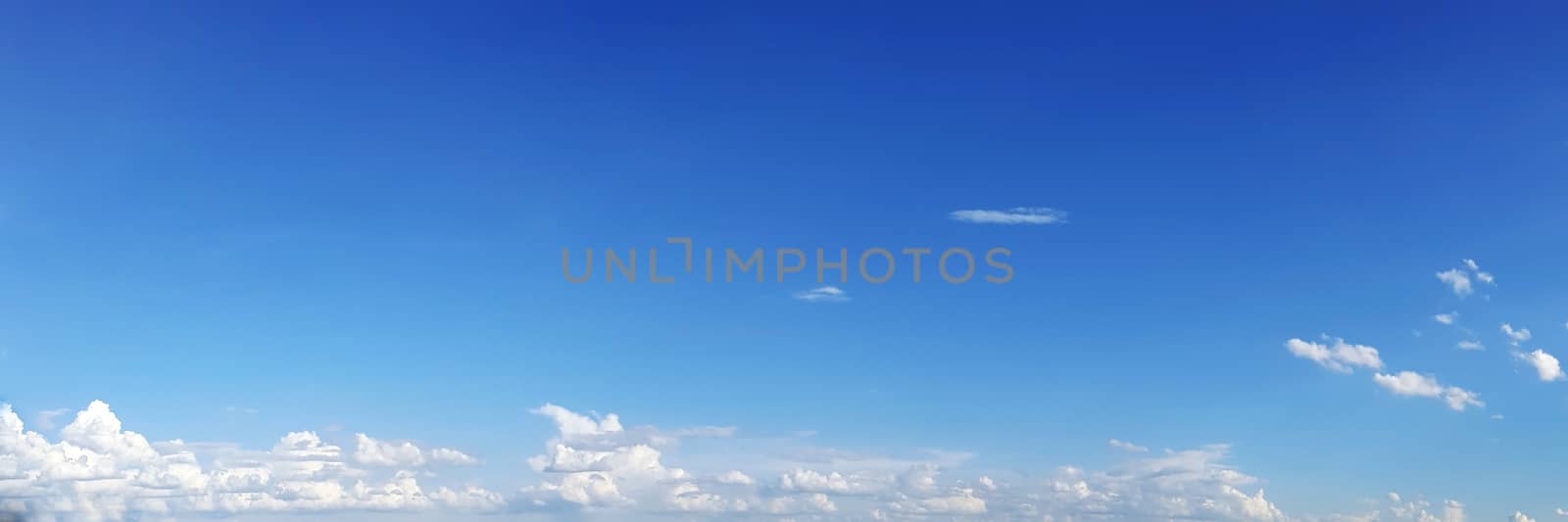 Blue sky with clouds on a sunny day. Beautiful cumulus cloud.