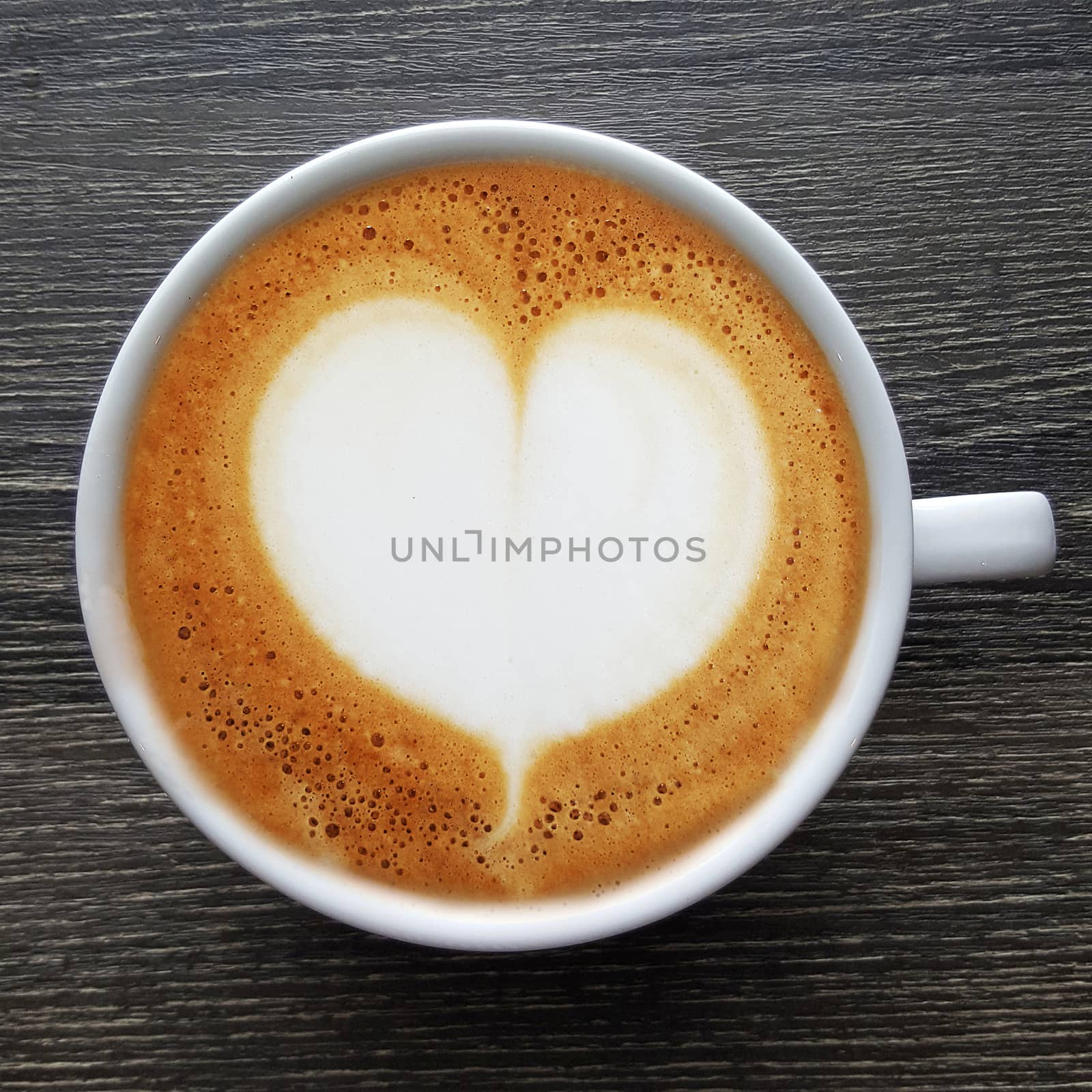 Top view of a mug of latte art coffee. by Tanarch