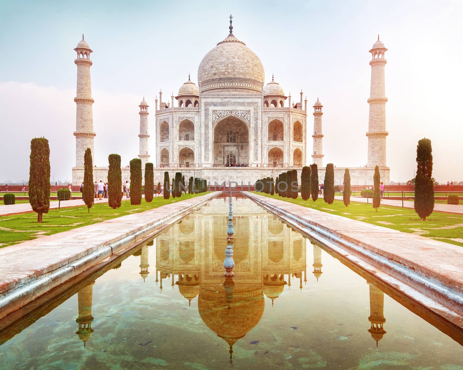 Sun rise at Taj Mahal front view reflected on the reflection pool, an ivory-white marble mausoleum on the south bank of the Yamuna river in Agra, Uttar Pradesh, India.