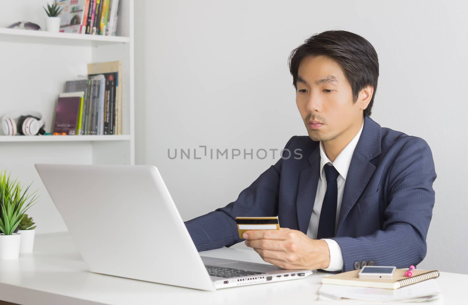 Asian Businessman in Formal Suit Shopping Online by Credit Card  by steafpong