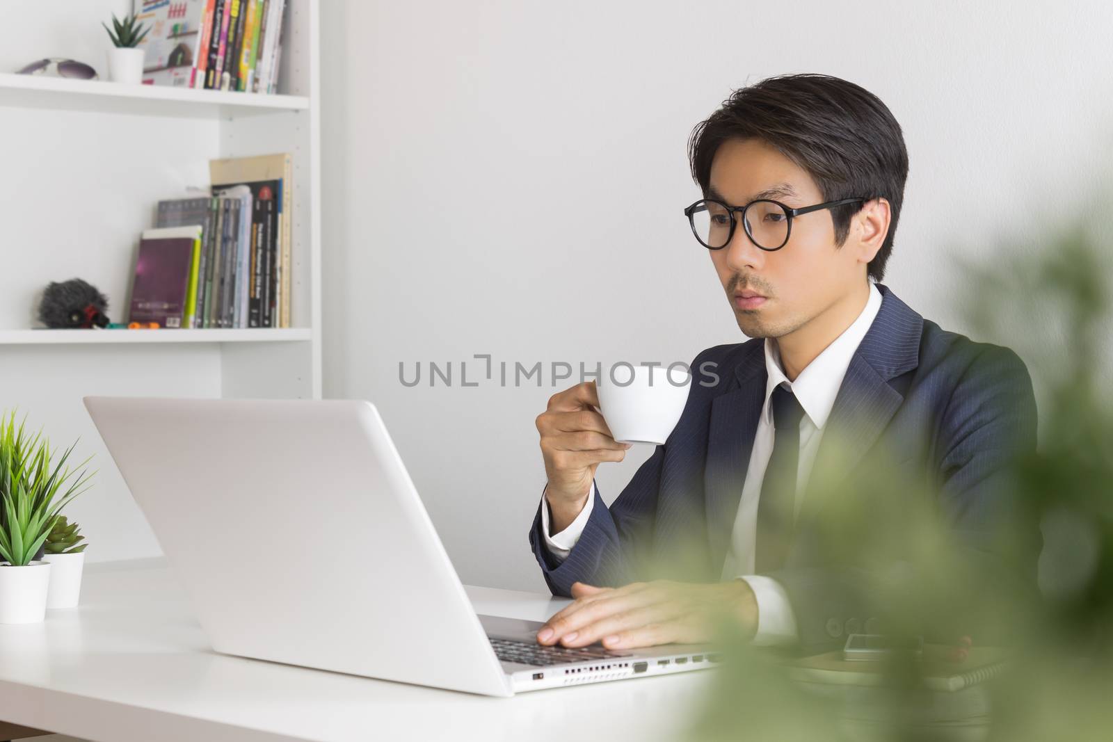 Asian Businessman Wear Eyeglasses with Coffee Cup by steafpong