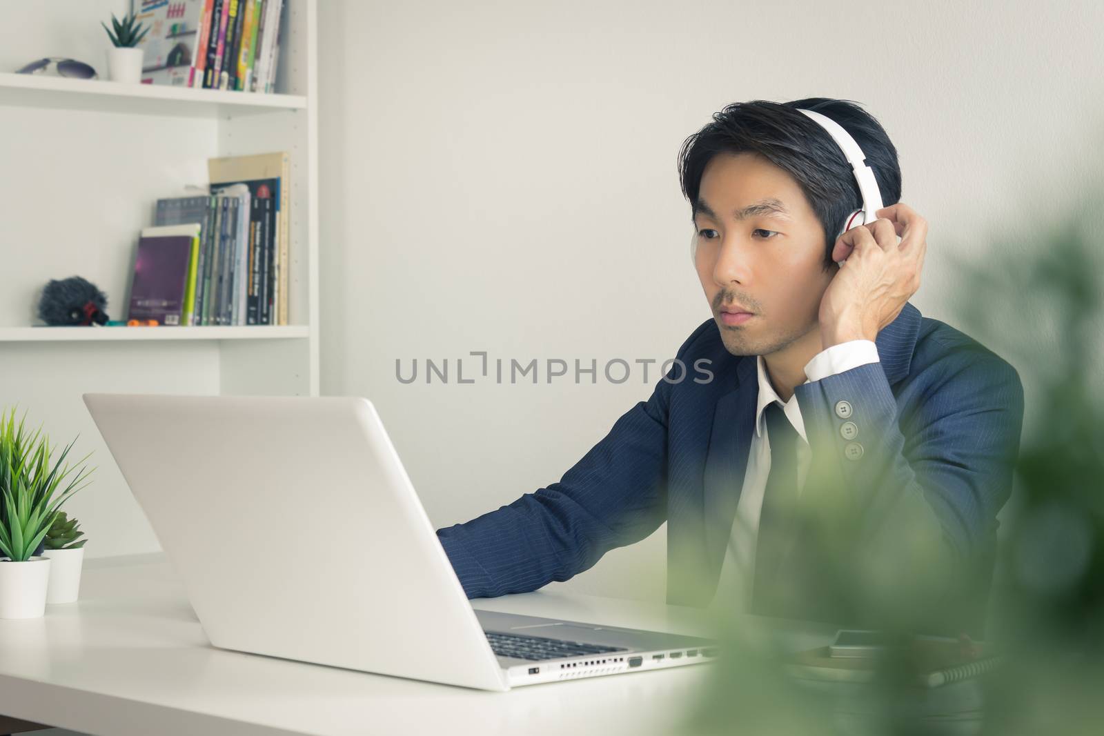 Asian Man Call Center Communicate with Customer via Internet by  by steafpong