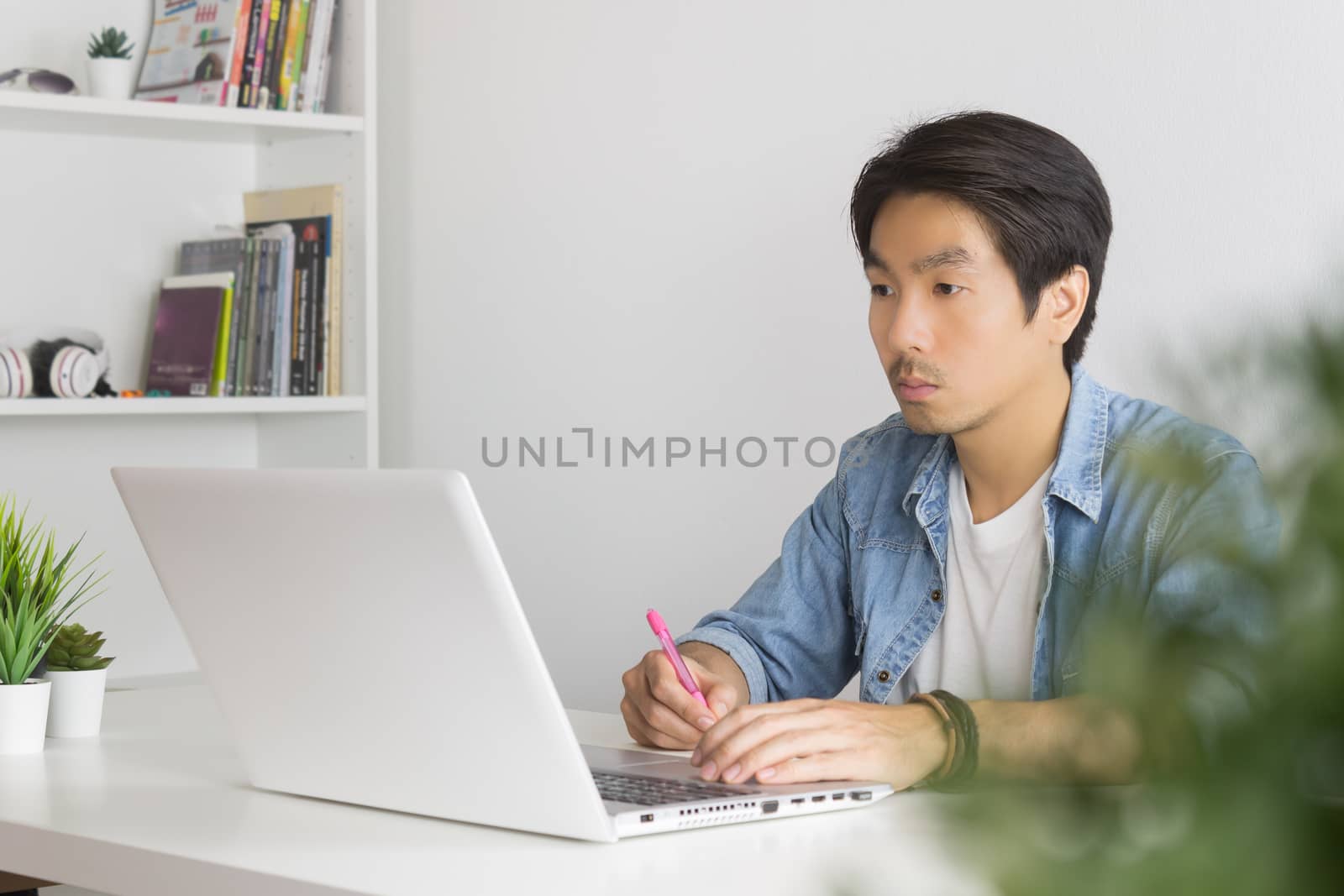 Asian Casual Businessman or Freelancer Working with Laptop and N by steafpong