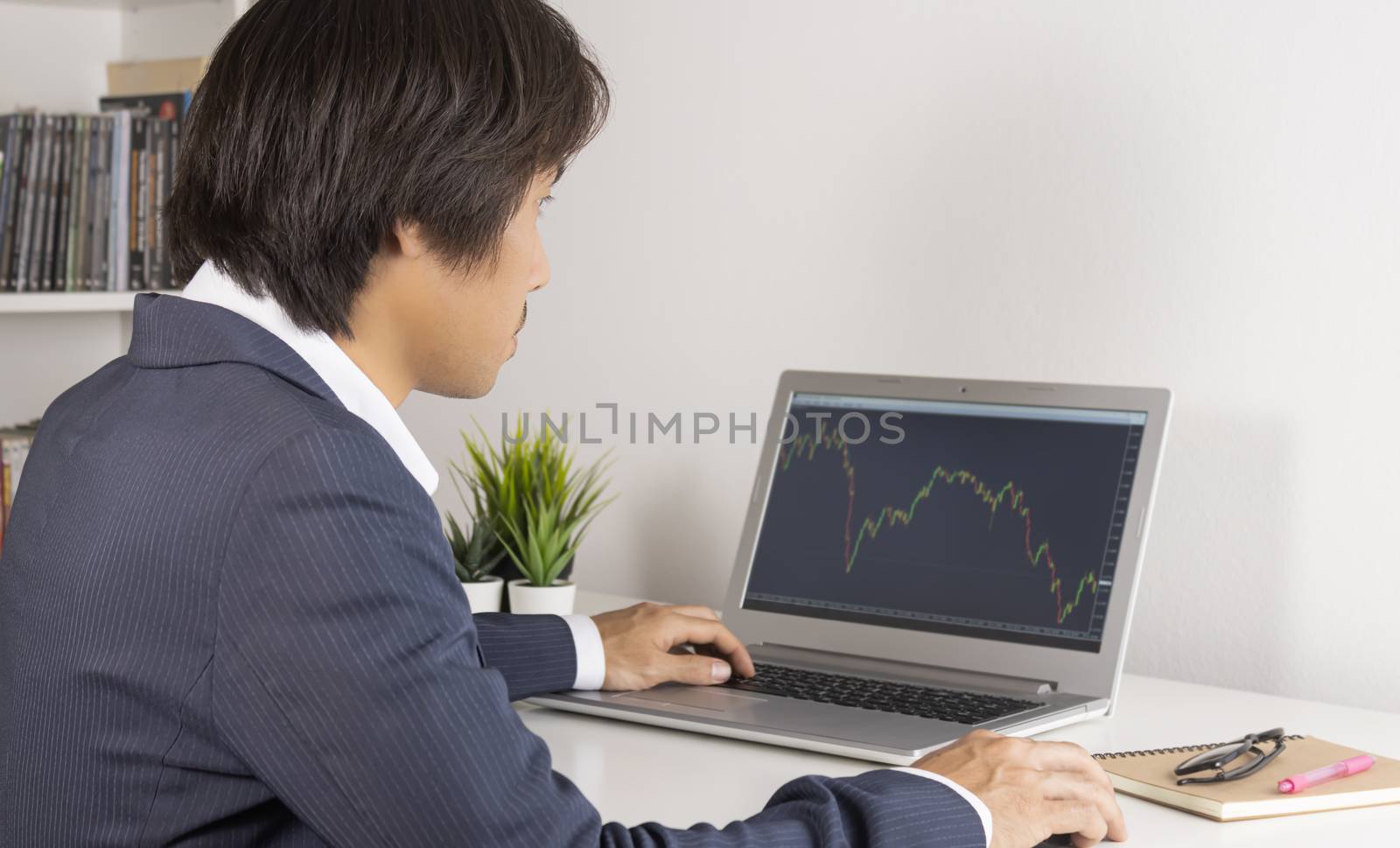 Young Asian Forex Trader or Investor in Suit Trading Forex or St by steafpong