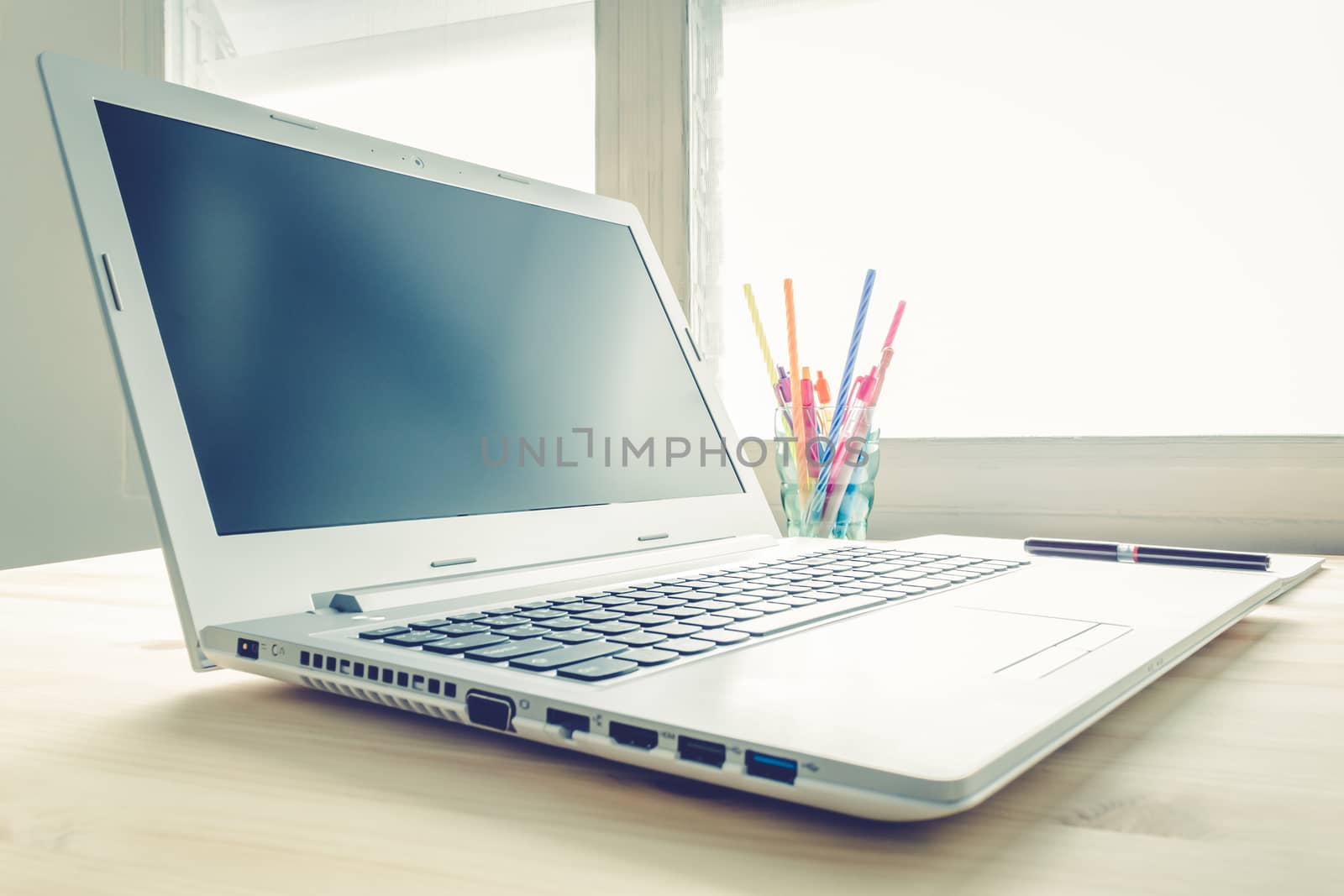 Laptop and Notebook and Pen on Wood Table Vintage Style by steafpong