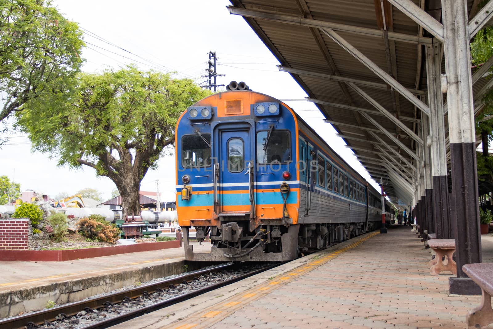 The train stops at train stations for passengers traveling  

in Thailand