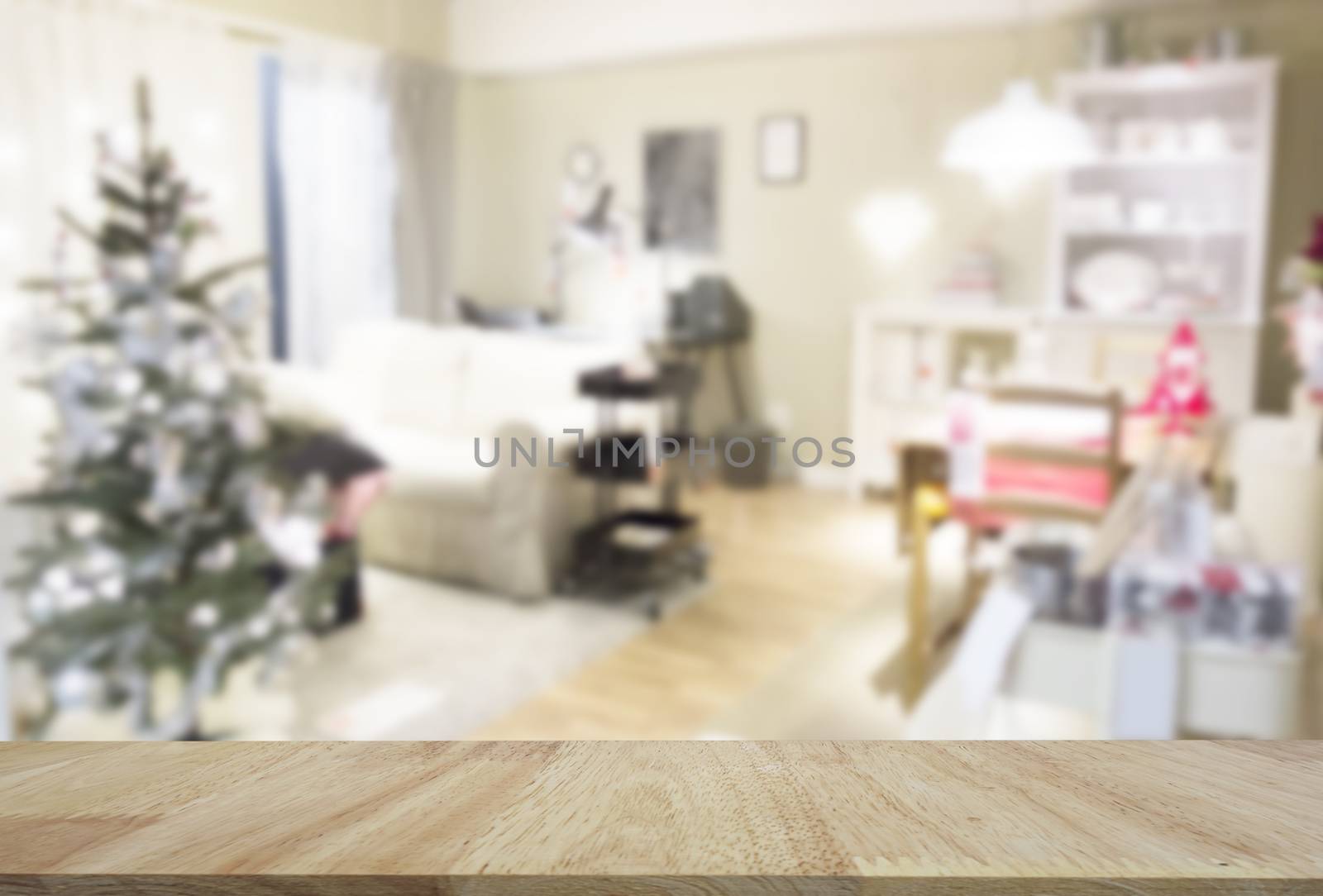 Blur Home Concept : OAK wood Table top for product dispaly with background. Merry Christmas and Happy Holidays! A beautiful living room decorated for Christmas. Beautiful holiday decorated room with Christmas tree, lamp and armchair. Cozy winter scene. White interior with lights.