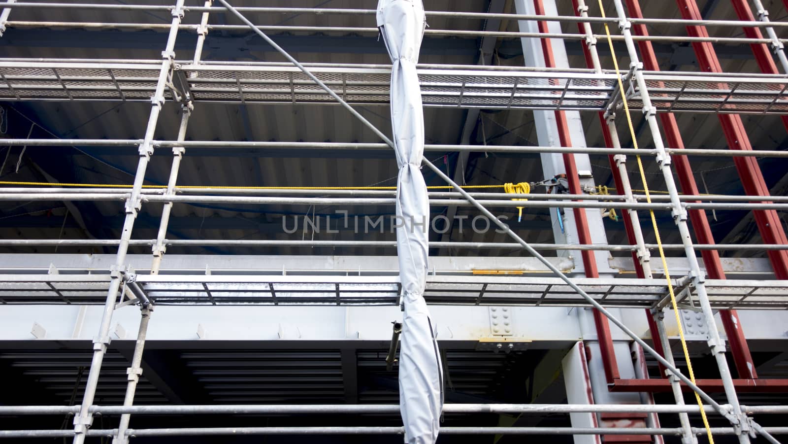 Scaffolding around the building for the construction. Construction building with Scaffolding around the building and High lifting cranes are working. 