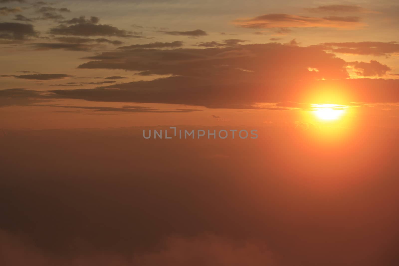 The sun is rising in the morning over the top of the hill.