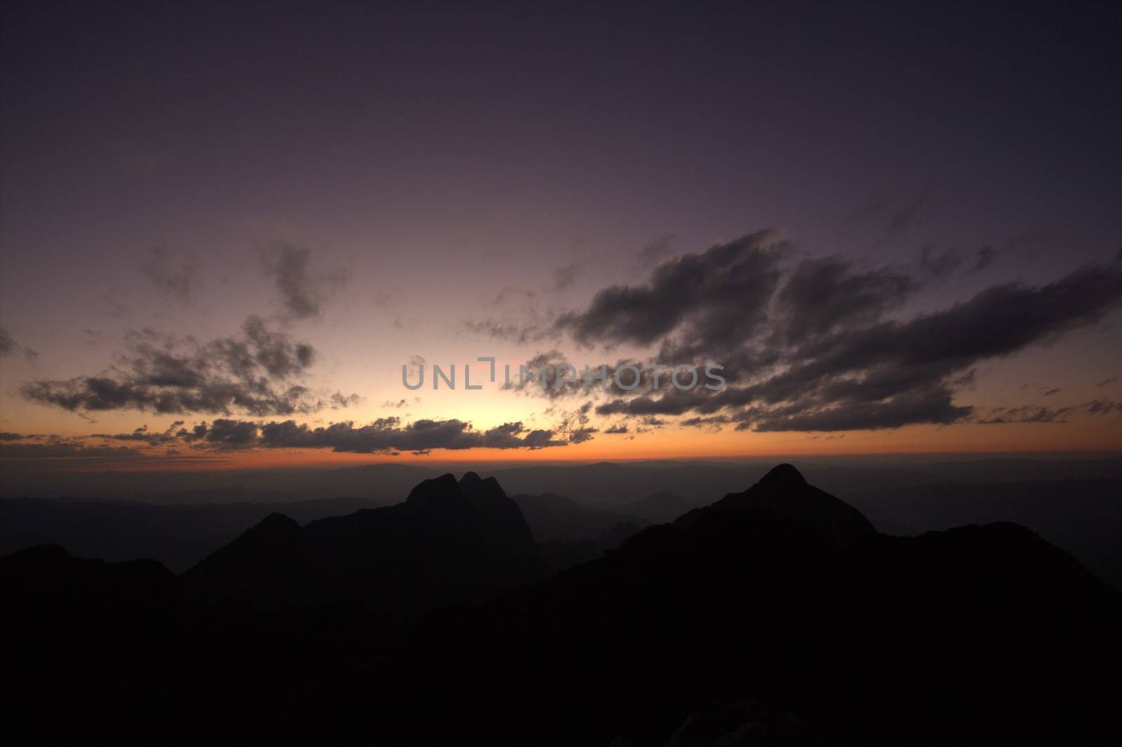 Twilight, beautiful orange light after sunset over the top of the hill.