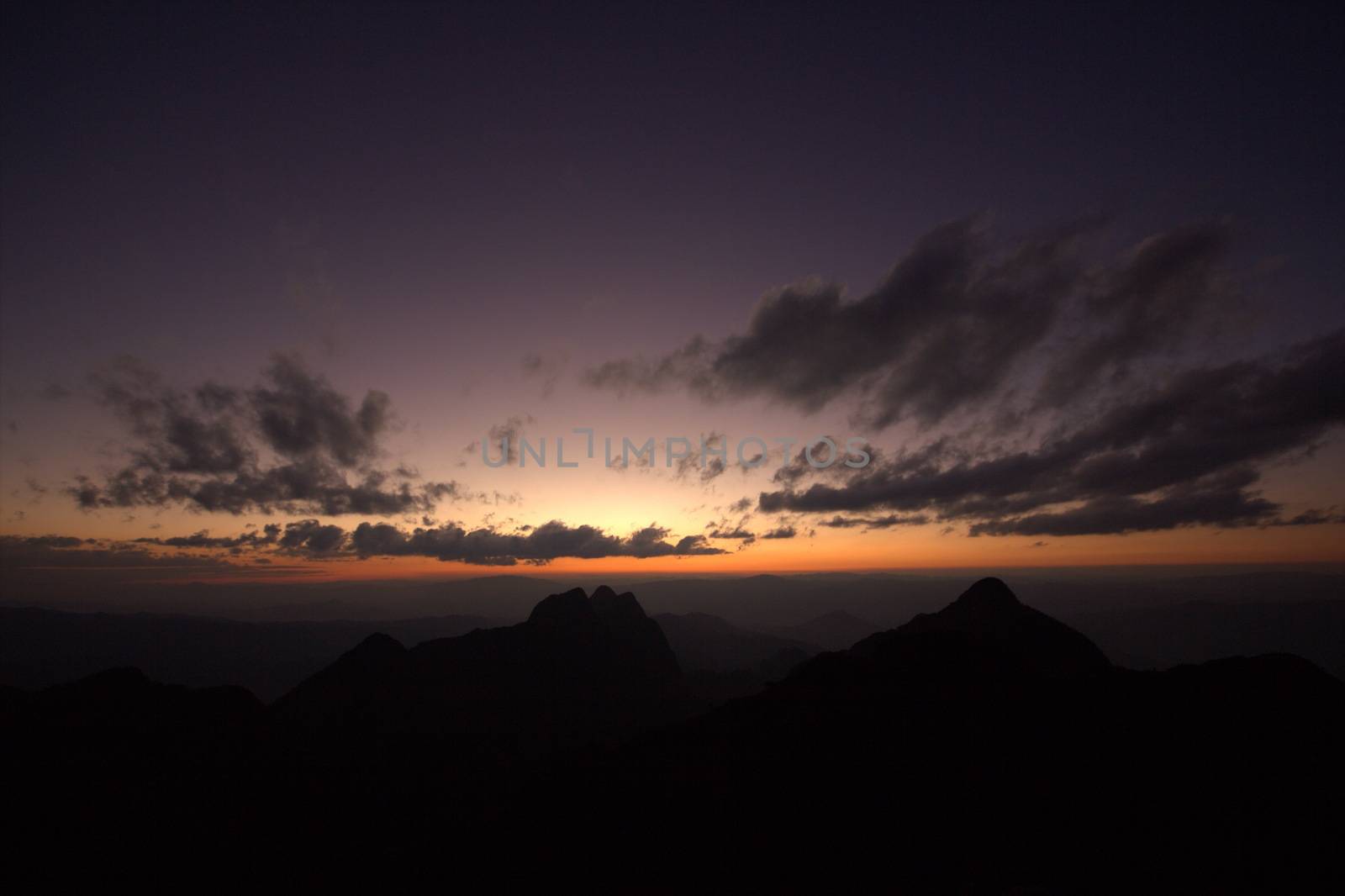 Twilight, beautiful orange light after sunset over the top of the hill.