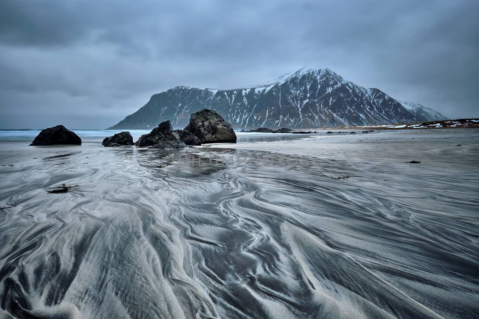 Rocky coast of fjord of Norwegian sea in winter. Skagsanden beach, Lofoten islands, Norway