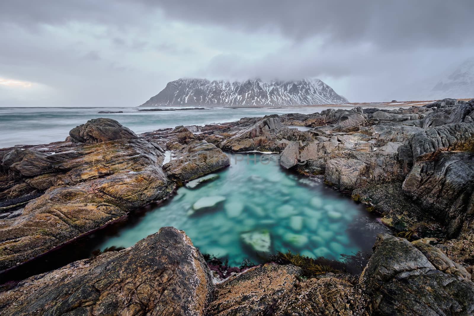 Rocky coast of fjord of Norwegian sea in winter. Lofoten islands, Norway