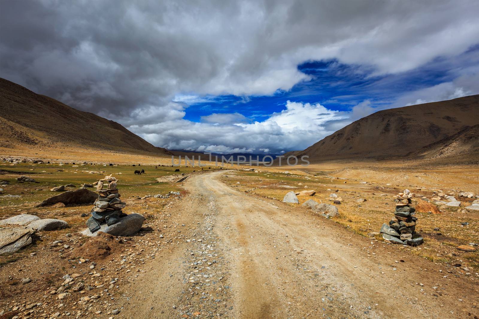 Road in Himalayas with stone cairns. Ladakh, Jammu and Kashmir, India