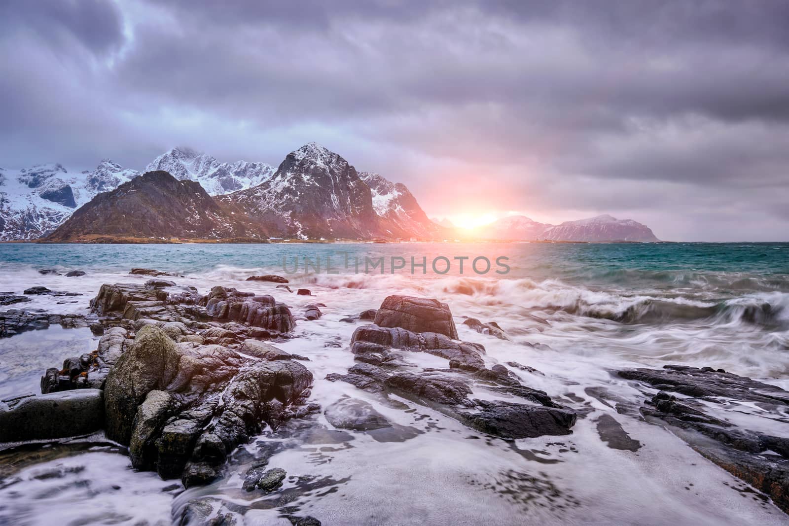 Rocky coast of fjord of Norwegian sea in winter on sunset. Vareid, Lofoten islands, Norway