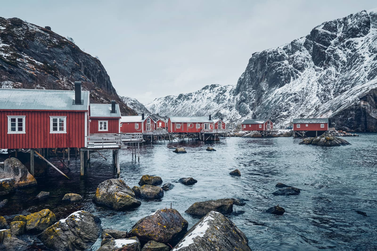 Nusfjord authentic traditional fishing village with traditional red rorbu houses in winter in Norwegian fjord. Lofoten islands, Norway