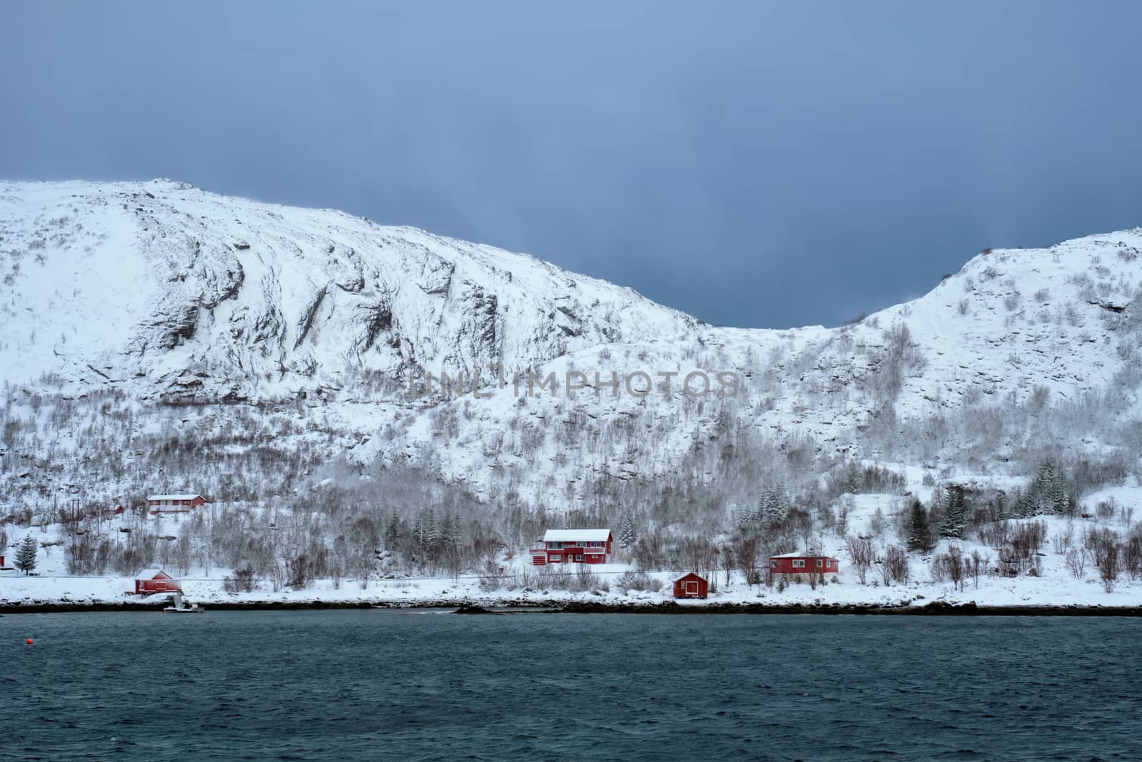 Rd rorbu houses in Norway in winter by dimol