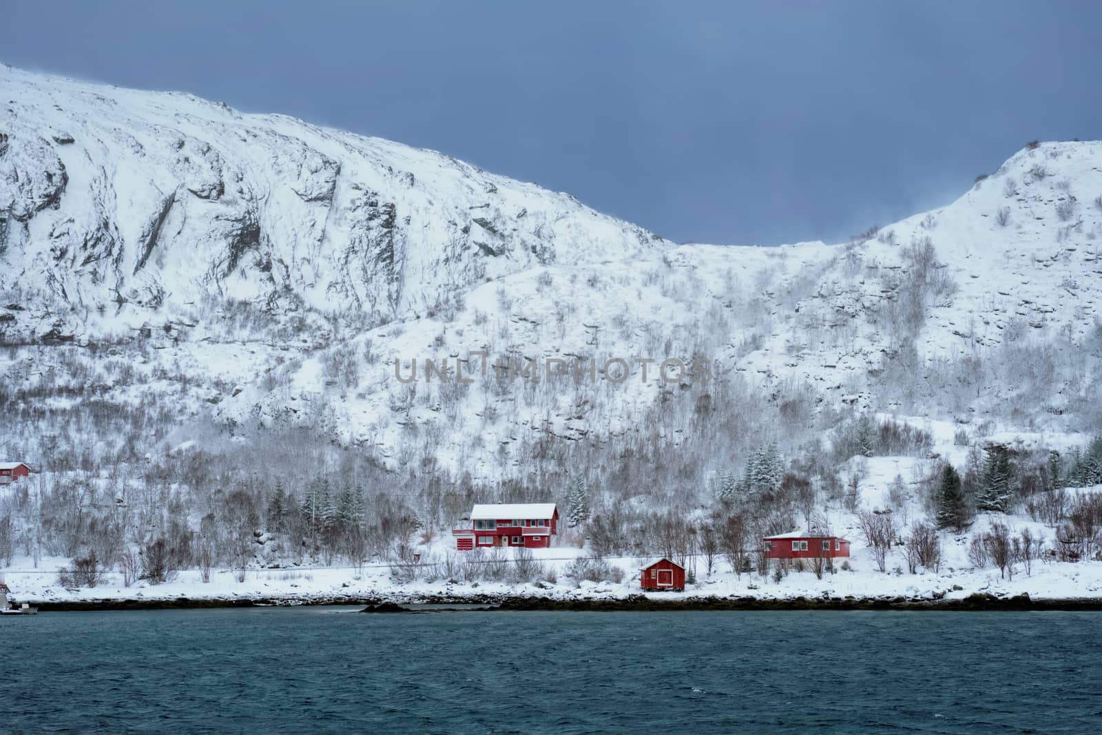 Rd rorbu houses in Norway in winter by dimol