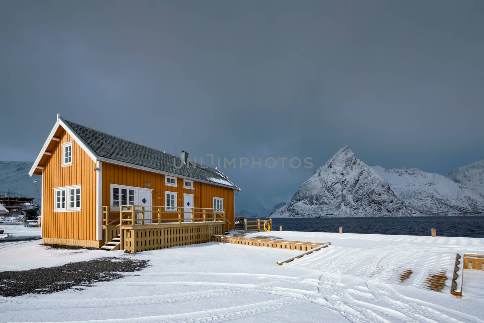 Yellow traditional rorbu house in Sakrisoy fishing village in winter on Lofoten Islands, Norway