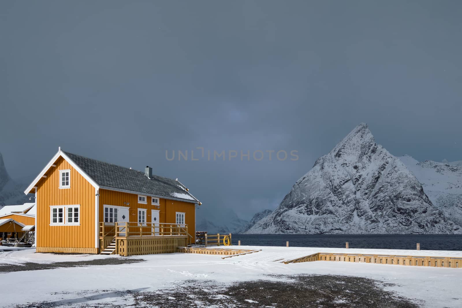 Yellow traditional rorbu house in Sakrisoy fishing village in winter on Lofoten Islands, Norway