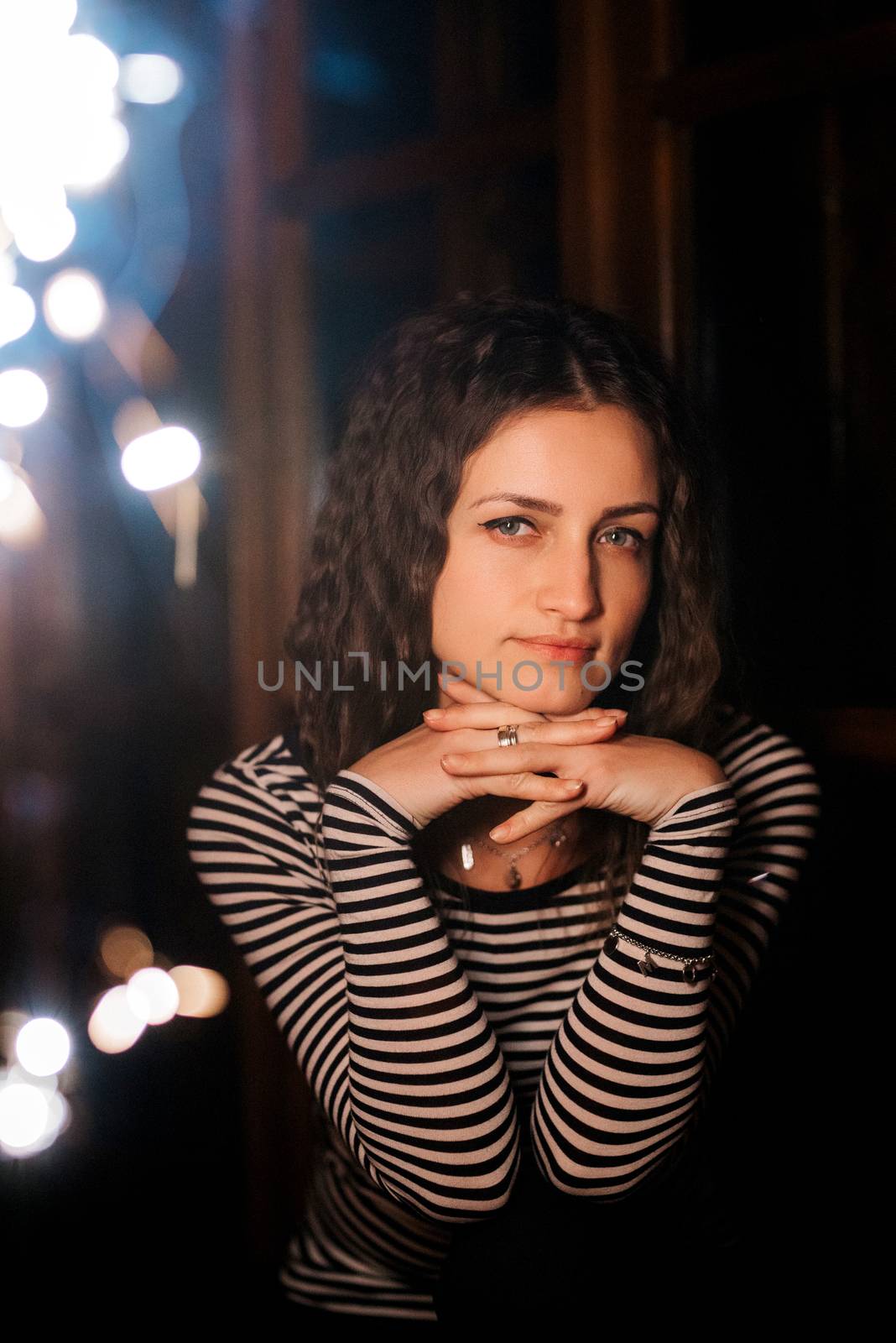 girl lit sparklers inside a wooden house late at night