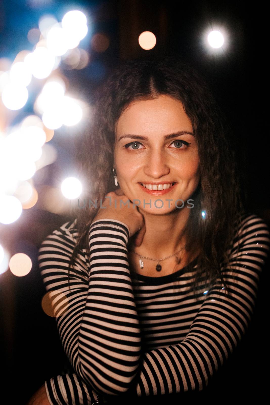 girl lit sparklers inside a wooden house late at night