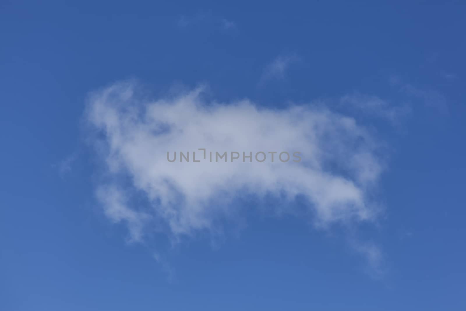 Background of a one single cumulus cloud with a blue clear sky