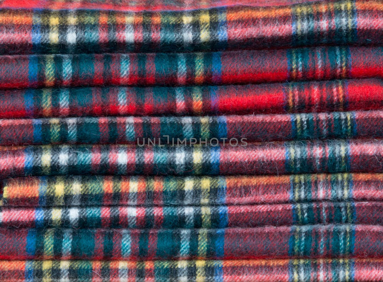 A pile of tartan scarves