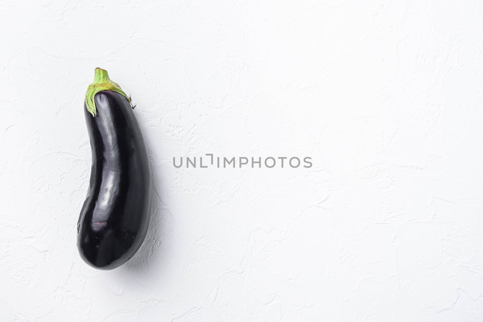 Ripe aubergine or eggplant on white background Top view, space for text. by Ilianesolenyi