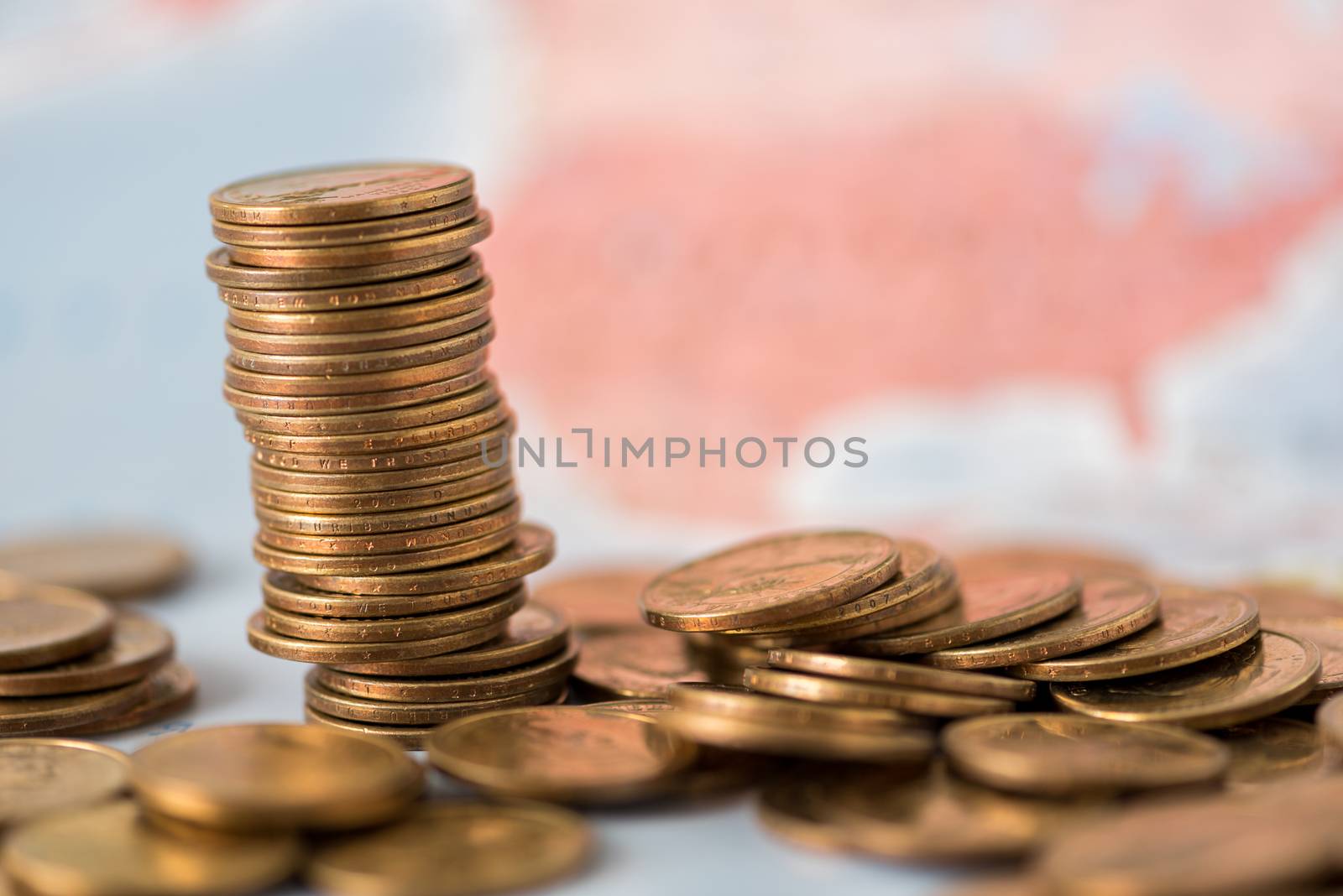 coins stack on world map background by Lerttanapunyaporn