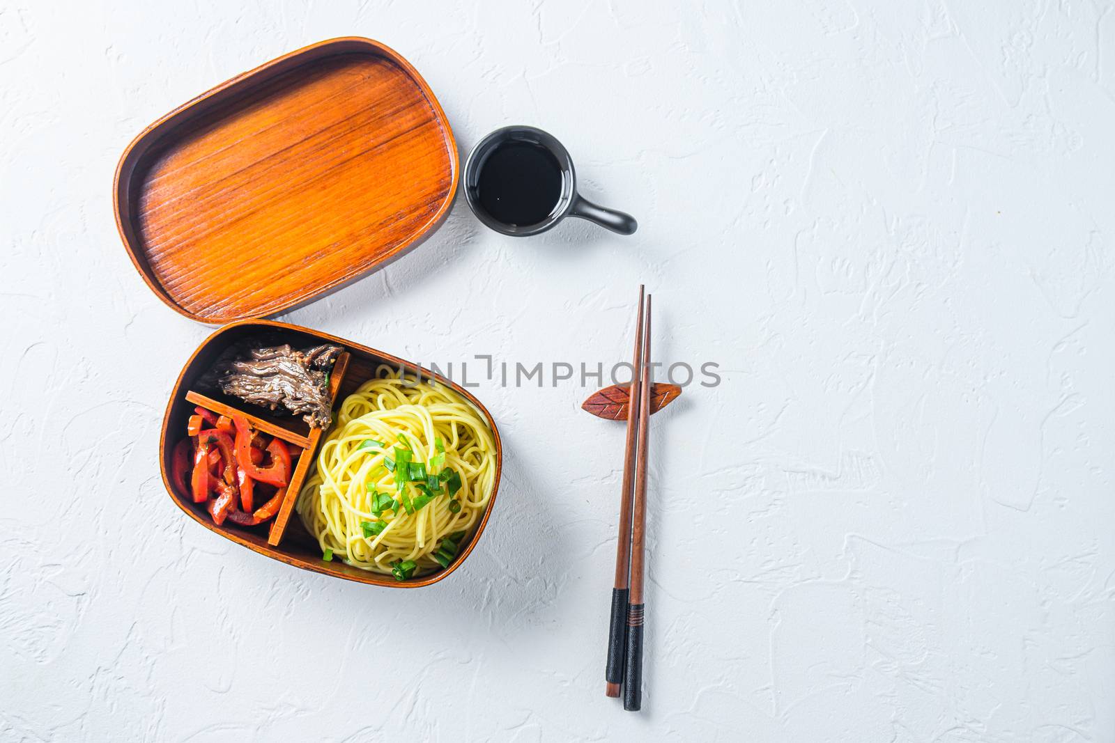 Bento beef noodles lunch box top view space for text on white table