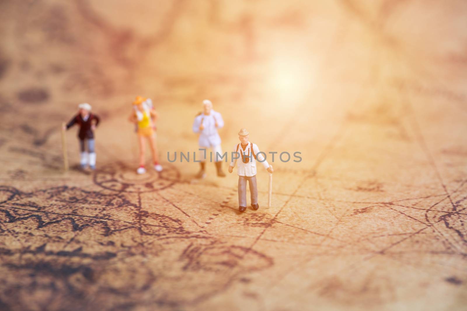 miniature traveler on vintage world map