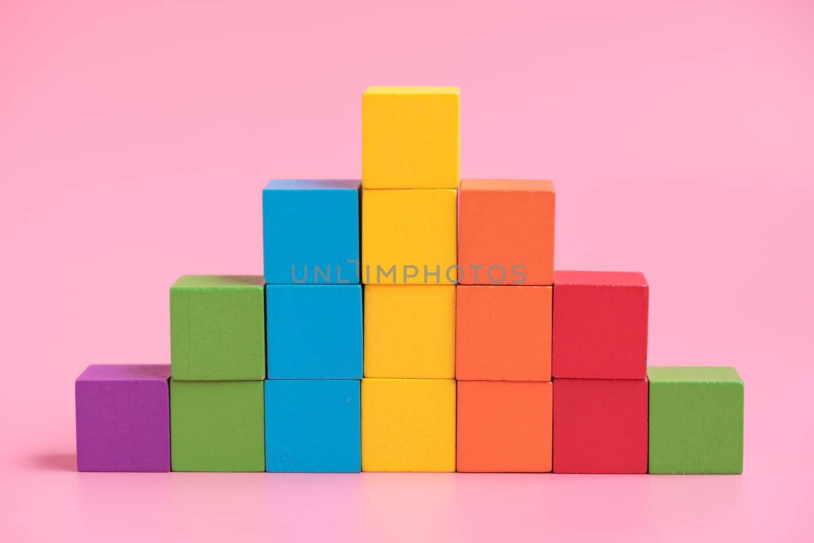 Colorful stack of wood cube building blocks.