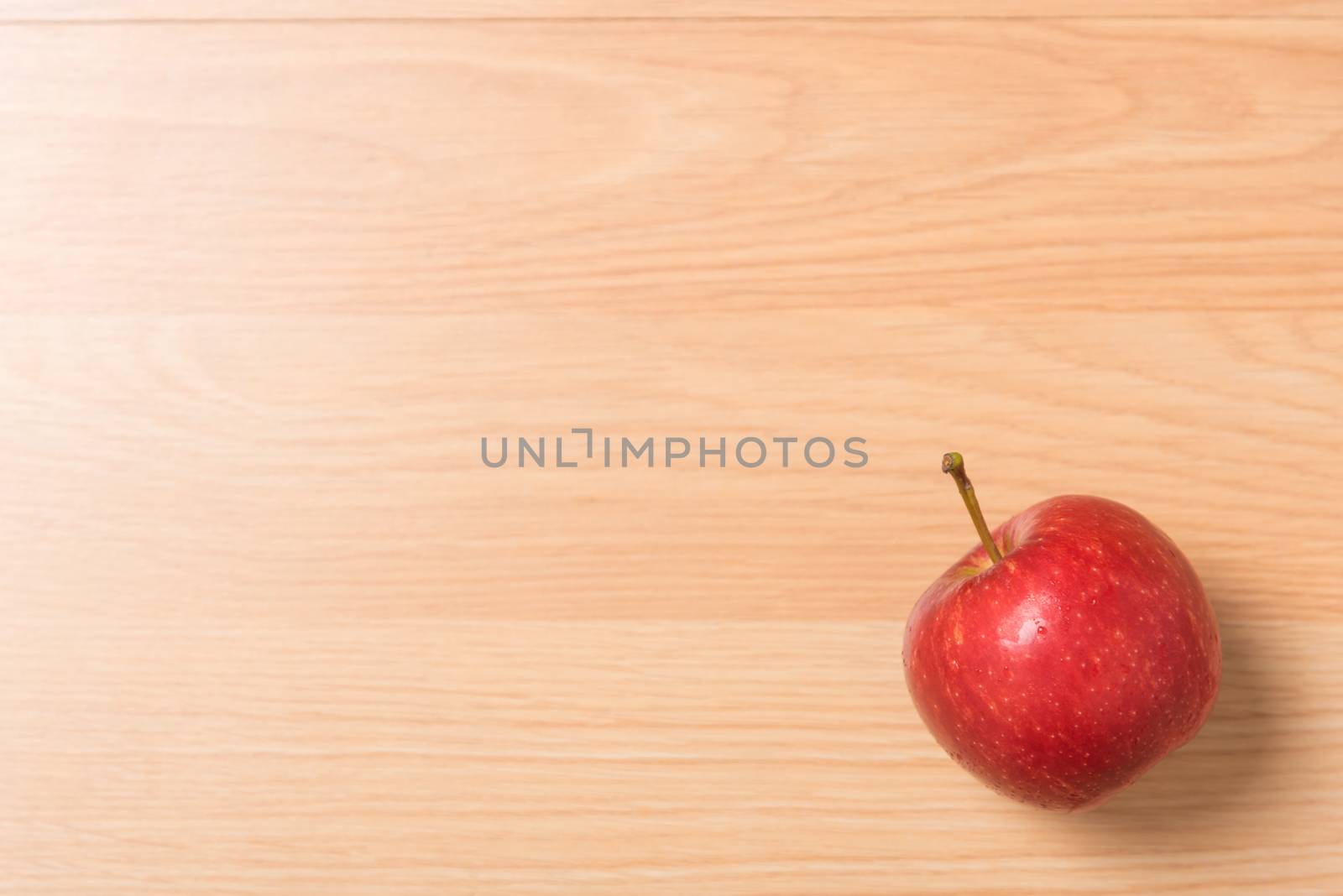 red apple on wood background.