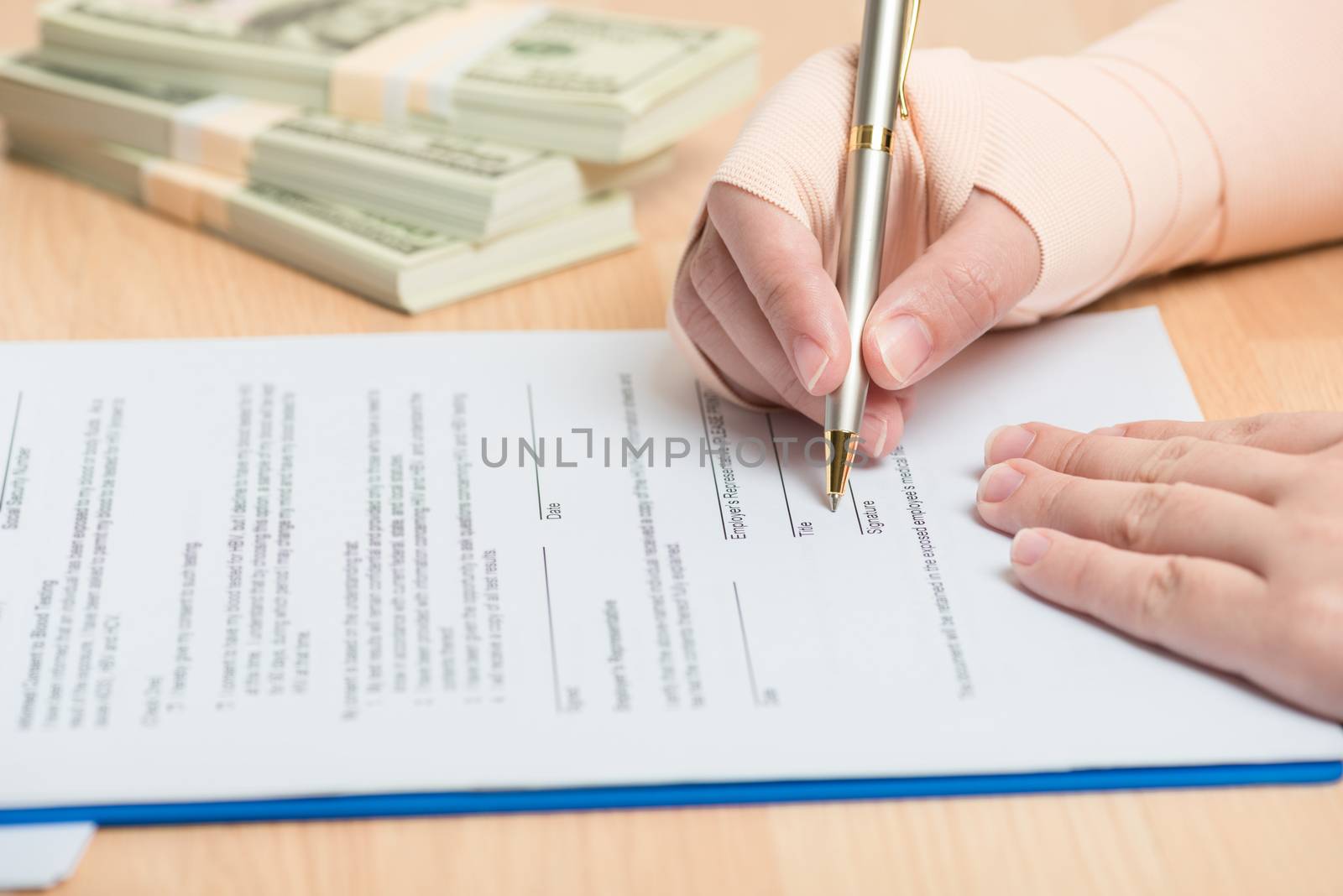 woman hand holding a pen sign the signature  in insurance form.