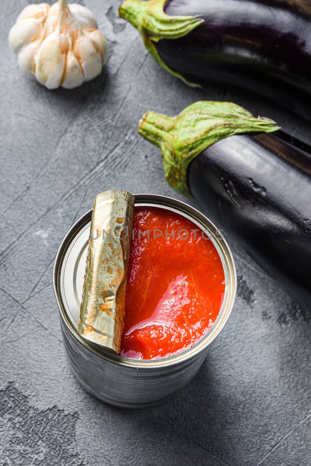 Tomatoe sauce canned ingredients eggplant pasta, pepper tomatoe sauce, on grey background side view selective focus. by Ilianesolenyi