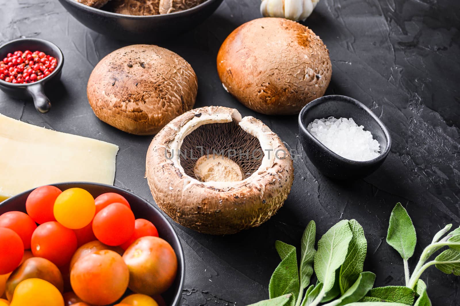 Garlicky mushrooms ingredients, portabello cheddar cheese and sage for baking on black background. Side view. by Ilianesolenyi