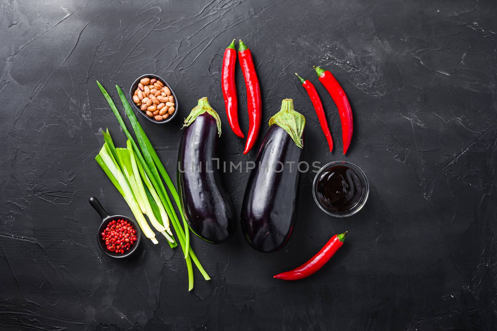 Sticky teriyaki aubergine ingredients, for cooking or grill chili pepper, eggplant, sauce, nuts on black background by Ilianesolenyi