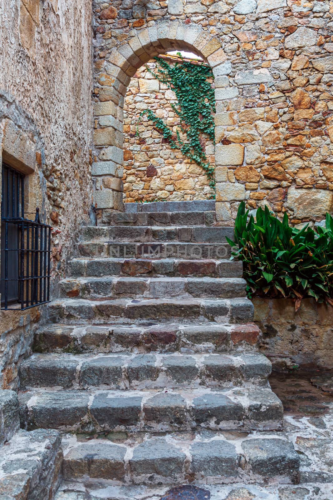Castle de Pals, a staircase leading through an arch to the center of the castle. Pals, Spain