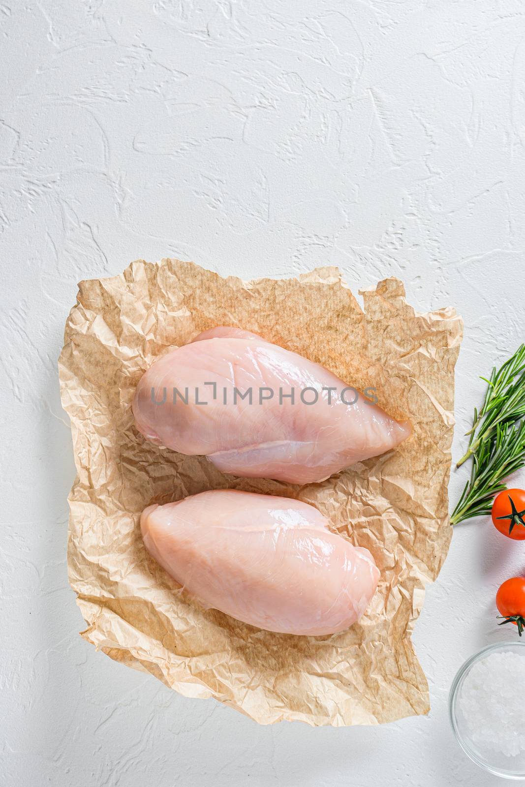 Fresh raw organic chicken fillet, spices and herbs on white concrete background, top view by Ilianesolenyi