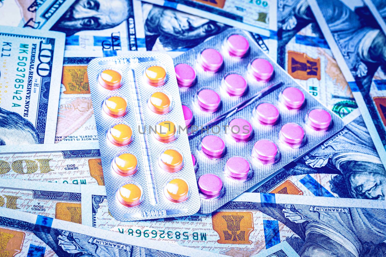 Plate with pills on the background of one hundred dollar bills. The concept of the expensive cost of healthcare or financing medicine.