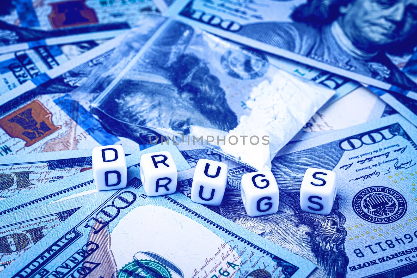 A bag with white narcotic powder like heroin or cocaine on the background of one hundred dollar bills. The concept of the use and sale of drugs.