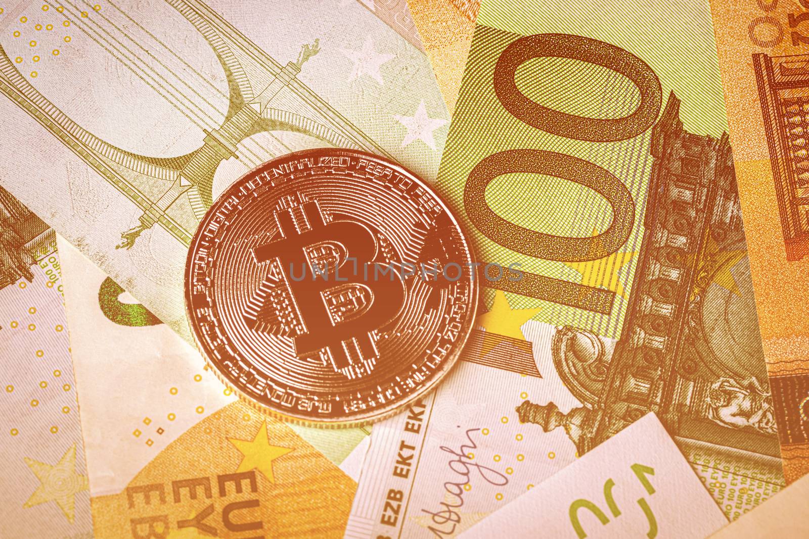 Euro bills and metal souvenir bitcoin. The concept of electronic money and commerce. Cryptocurrency and cash.