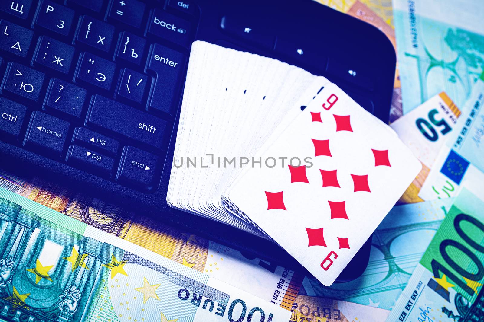 Euro bills, a deck of playing cards and a black keyboard. Concep by Eugene_Yemelyanov