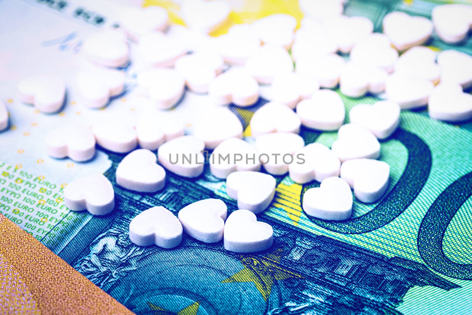 Heart-shape pills on the background of euro bills. The concept o by Eugene_Yemelyanov