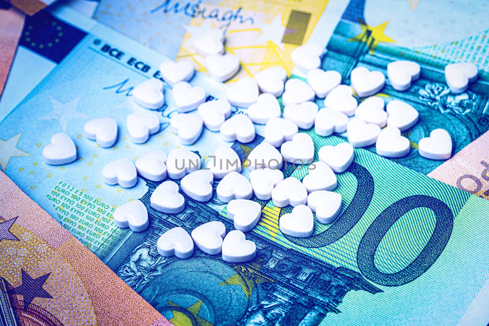 Heart-shape pills on the background of euro bills. The concept o by Eugene_Yemelyanov