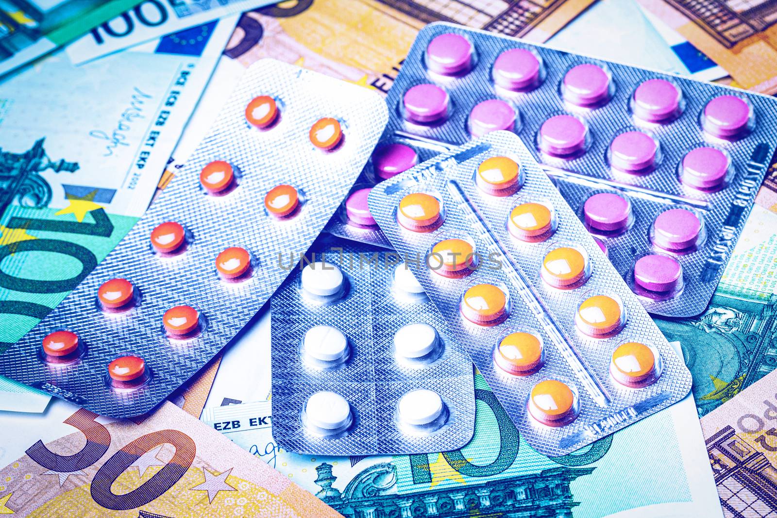 Plate with pills on the background of euro bills. The concept of by Eugene_Yemelyanov